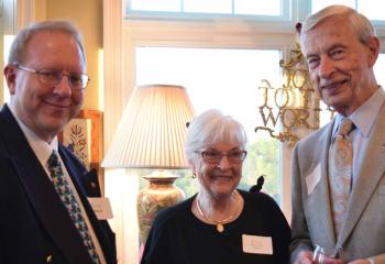 Bob Wert, left, talks with Mary Lou and Vincent Parisi.