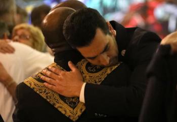 People mourn during an interfaith memorial service Oct. 2 in Las Vegas for victims of a shooting spree directed at an outdoor country music festival late Oct. 1. A gunman perched in a room on the 32nd floor of a casino hotel unleashed a shower of bullets on the festival below, killing at least 59 people and wounding another 527. (CNS photo/Lucy Nicholson, Reuters) 