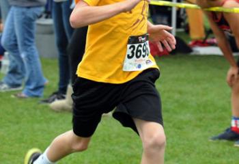 Chase Eller of St. Theresa of the Child Jesus, Hellertown is the first of the fifth- and sixth-grade boys to reach the finish.