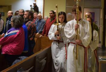 Altar servers lead the procession for the holy hour.