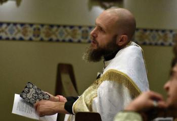 Father Zelonis prays the rosary during “Culture of Encounter.”