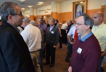 Speaker Marty Rotella, left, talks with Vincent Santvcci, parishioner of Assumption BVM, Northampton, during one of the conference breaks.