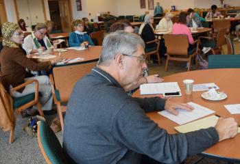 Participants take notes about strategies for time management.