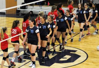 Volleyball players from La Salle Academy, Shillington (blue) congratulate the team from St. Thomas More, who advanced to the championship match.