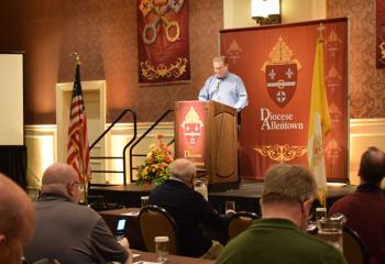 Msgr. Victor Finelli welcomes priests to Bishop Alfred Schlert’s presentation.