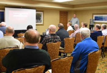 Msgr. William Glosser, standing, right, and Father Brian Miller, middle, manning the video equipment, present “The Parochial Relationships of a Priest: The Difference Between Spiritual Direction and Pastoral Counseling” during a Nov. 9 session. 