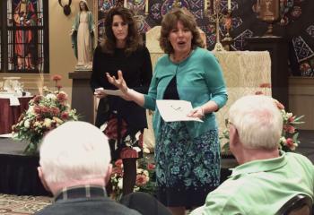 Maryanne Morales, fertility care practioner in Dr. MaryAnne Freeman-Brndjar’s office, right, addresses priests with Dr. Freeman-Brndjar, left, who presented “Pastoral Directives for Natural Family Planning.”