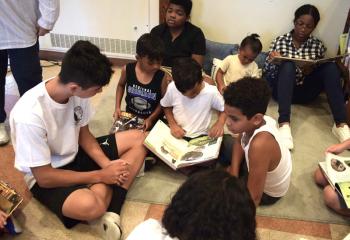 Children read together after breakfast. (Photo by John Simitz)