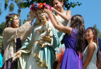 Schoolgirls participate in a May crowning ceremony in 2013 on the grounds of Immaculate Heart High School and Middle School in Los Angeles. Meghan Markle, who recently got engaged to Britain's Prince Harry, graduated from the all-girls school in 1999. (CNS photo/courtesy Immaculate Heart High School & Middle School)