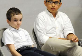 Sixth-graders Benjamin McCabe of St. Ann School, Emmaus, left, and Diego Mihura of St. Thomas More School, Allentown, await their turns.