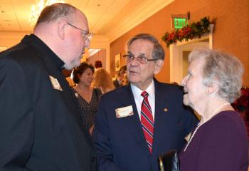 Msgr. David James, left, enjoys talking with Joseph and Elizabeth Bechtel.