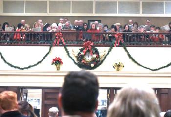 Parishioners listen to the Cathedral Choir sing the recessional hymn at the conclusion of the liturgy.