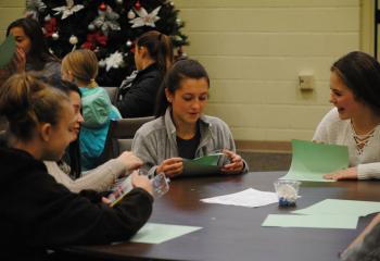 Creating cards for prisoners are, from left, Madeline Sierzega, Meredith Steirer, Andrea Monklewicz and Emma Lincoln. (Photo by Tara Connolly)