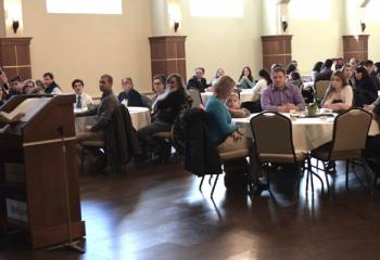 Mary Fran Hartigan, secretary of the Secretariat for Catholic Life and Evangelization, welcomes winners and family members to the annual “Stand Up for Life” essay contest banquet at St. Francis of Assisi, Allentown. 