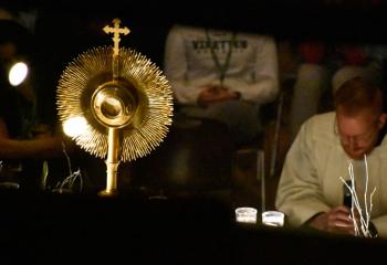 Father Mark Searles prays with students before the Blessed Sacrament Dec. 15 during the close of Forty Hours at Allentown Central Catholic High School (ACCHS).