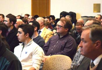 Michael D’Agostini, parishioner of the Cathedral of St. Catharine of Siena, Allentown, front in white quarter-zipped sweater, is among the men listening to Fradd make a point during the evening session co-sponsored by the Diocesan Secretariat for Catholic Life and Evangelization and DeSales University.