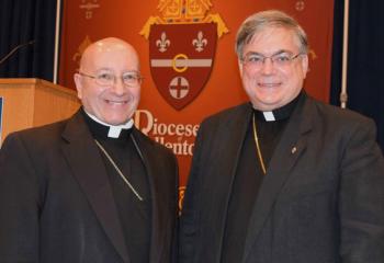 Bishop William Waltersheid, left, greets Bishop Alfred Schlert after offering his morning presentations.