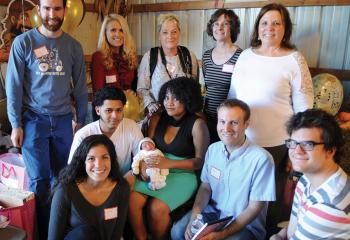 Eric Rosario and Shannet Cuascut hold Jaivian surrounded by pro-life members, from left: front, Annaleigh Atiyeh, Mike Israel and Nick Gidosh; back, Reggie Pierce, Maggie Sweet, Victoria Naoe, Mary Paris and Joyce Mazalewski. (Photo by Ed Koskey)