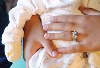 Shannet Cuascut holds Jaivian during the happy occasion. (Photo by Ed Koskey)