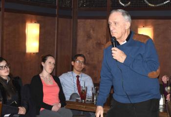 Among those listening to Father Frederick Riegler make a point are, from left, Francesca Frias, Thea Aclo and her husband Allan Aclo.