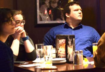 Enjoying Father Frederick Riegler’s presentation are, from left, Clare Behe, Catherine Elliot and Matt Brumley.