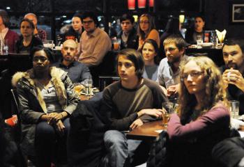 Adults listen to the discussion during the monthly Theology on Tap.