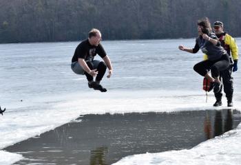 Dr. Christopher Cooper, left, principal of St. Joseph Regional Academy, Jim Thorpe, and Betty McCall, fourth-grade teacher, plunge into Mauch Chunk Lake, Jim Thorpe Jan. 27 as part of the school’s “Be Cool for Our School Polar Plunge." (Photo by John Simitz)