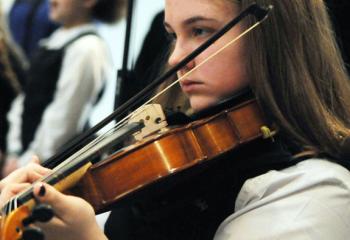 Ryanna Kral, eighth grade student at Our Lady of Perpetual Help School, Bethlehem, plays the violin Jan. 31 during a CSW Mass celebrated by Bishop of Allentown Alfred Schlert. (Photo by Ed Koskey)
