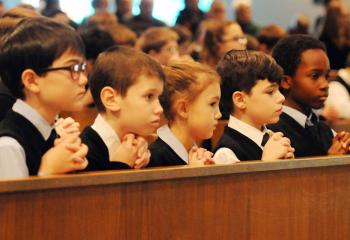 Third-grade students at Our Lady of Perpetual Help School, Bethlehem praying during Mass for CSW are, from left, Derrick Hartman, Brayden Boyle, Ondine Murabet, Dana Clifford and Jayden Puirre. (Photo by Ed Koskey)