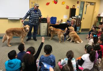 Steve and Barb Husja visit Our Lady Help of Christians School, Allentown to introduce service dogs and discuss the task each dog has been trained to provide for persons with disabilities. (Photo courtesy of Michael Hillegas)