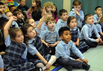 Kindergarten and preschool students at Holy Family School, Nazareth raise their hands with questions for Dan Skeldon, WFMZ-TV 69 meteorologist, during his Jan. 29 visit at the school. (Photo by Ed Koskey)