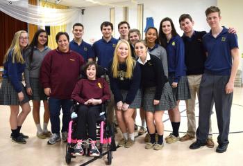 Elizabeth Grys, principal of Mercy School for Special Learning, Allentown, third from left, and Savanna Phillips, student, front, welcome students from Notre Dame High School, Easton for a day of fun and games to celebrate CSW, “Learn. Serve. Lead. Succeed.” (Photo by John Simitz)