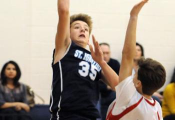 St. Ignatius’ Griffen Rhein (35) shoots over St. Thomas More’s Ben Scandone (15) during semi-finals.