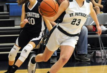 Kami Abdo (23) of St. Patrick, Pottsville drives the ball past St. Ignatius’ Mackenzie Gordos (10) during semi-finals March 4 at St. Joseph the Worker. 