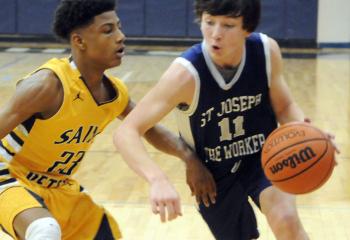 St. Joseph the Worker’s Mason Abromitis (11) looks to get by St. Peter’s DeShawn Wilson (23) during semi-finals. 