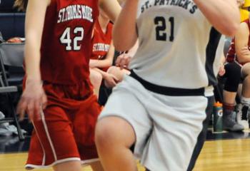 St. Patrick’s Taylor Welsh (21) looks to shoot the ball as St. Thomas More’s Emma DiComes (42) watches during the grade school girls’ championship.