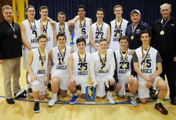 St. Joseph the Worker's CYO championship team. From left are: front, Sam Morgan, Adam Mellinger, John Jenkins, Josh Lee, Griffin Maxsim and Anthony Schrayer; back, assistant coach Buddy Kellar, Matthew Ceh, Tyler Hays, Michael Kellar, Gabriel Martinez, Shaun Coulter, Adam Zielinski, head coach Dan Maxsim and Msgr. Joseph Smith, in residence at St. Joseph the Worker and pastor emeritus of St. Catharine of Siena, Reading. 