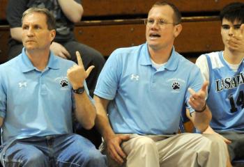 Giving signs to their players during a high school boys’ semi-finals game Feb. 24 with St. Joseph the Worker are, from left, LaSalle Academy’s head coach Jim Schuetz, assistant coach Barry Suski and Mark Equi (14).