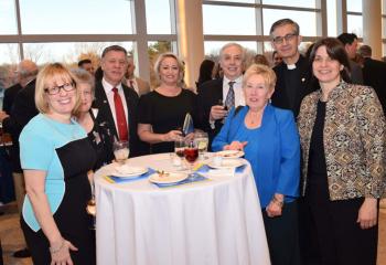 Barnabite Father Robert Kosek, administrator of St. John the Baptist, Allentown, enjoys the evening with some of his parishioners.