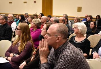 The audience enjoys the evening presentation.