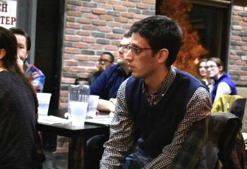 Joseph Marlin poses a question to James Doolin during the evening event.