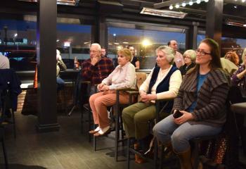 Adults gather at P.J. Whelihan’s Pub and Restaurant, West Lawn for “Faith and Spirits.”