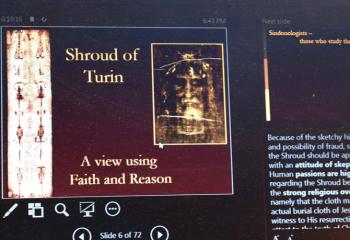 One of the slides during the talk highlights the importance of faith and reason while contemplating the authenticity of the Shroud of Turin.