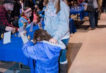 Maria Marzen, kneeling, and Mae Marzen venerate a relic at Our Lady of Perpetual Help, Bethlehem.