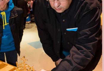 Mark Marino grasps the reliquary case containing a relic.