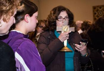 A woman kisses one of the relics.