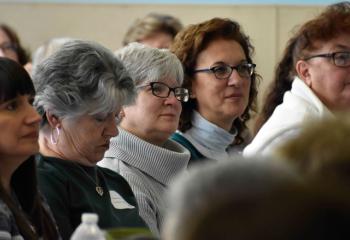 Women listen during the main presentation.