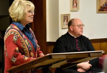 Marie Mazzini introduces Monsignor David James before his presentation.