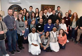 Speakers and retreatants gather for a photo.