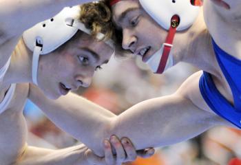 Locked in a head-to-head wrestling battle during the 126-pound bout are Becahi’s Kenny Herrmann, left, and Dalton Rohrbaugh, Spring Grove Area High School. Rohrbaugh took third place in the Class AAA state wrestling tournament by a slim 7 to 5 margin.